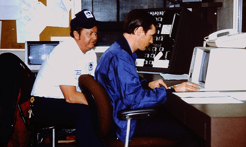 two men sit at a computer working on a website with Aviation Digital Marketing Services