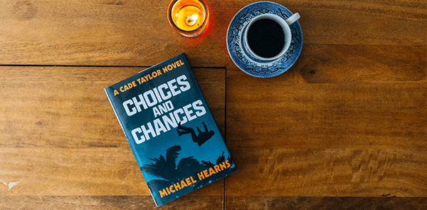 book Choices and Chances on a wooden table with coffee and candle