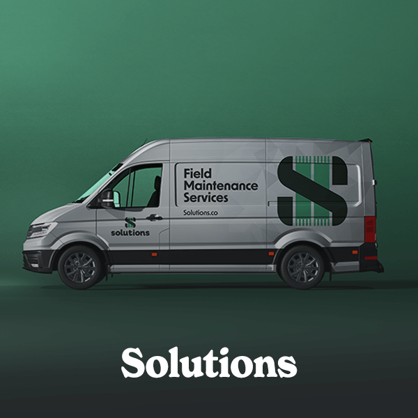 A modern gray and green wrapped van with text and logo, parked in a studio with a green background and floor, showcasing Cormorant Marketing's successful creation of a client's brand identity for Jacksonville FL businesses.