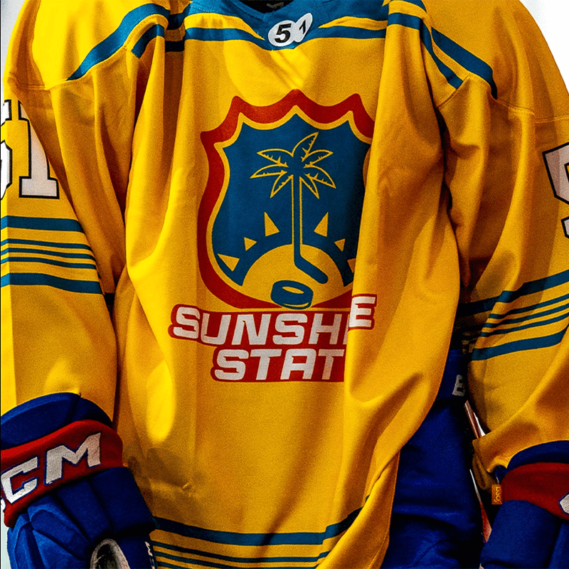 yellow hockey jersey with palm tree on it