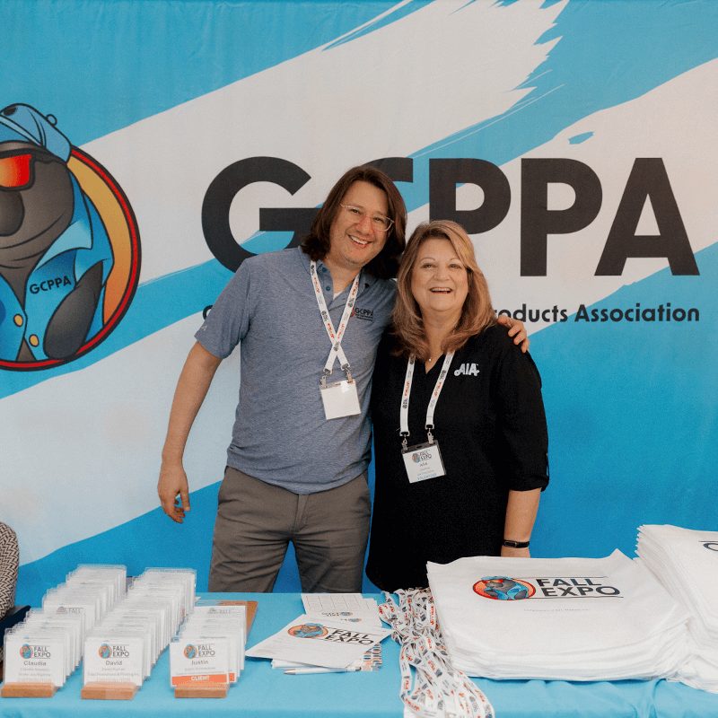 Gcppa Group Two people stand candidly infront of event marketing booth designed by cormorant marketing a jacksonville marketing agency