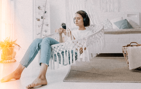 Woman on iphone looking dental practice woman scrolls on iphone sitting in hammock looking for jacksonville dental practices