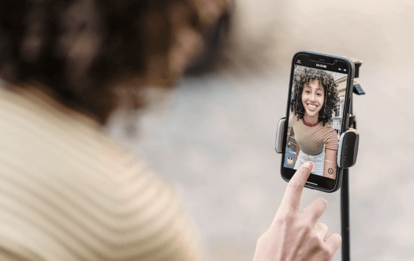 Jacksonville social media marketing for real estate an iphone reflects a woman smiling in camera, she is happy to be using real estate marketing services in jacksonville